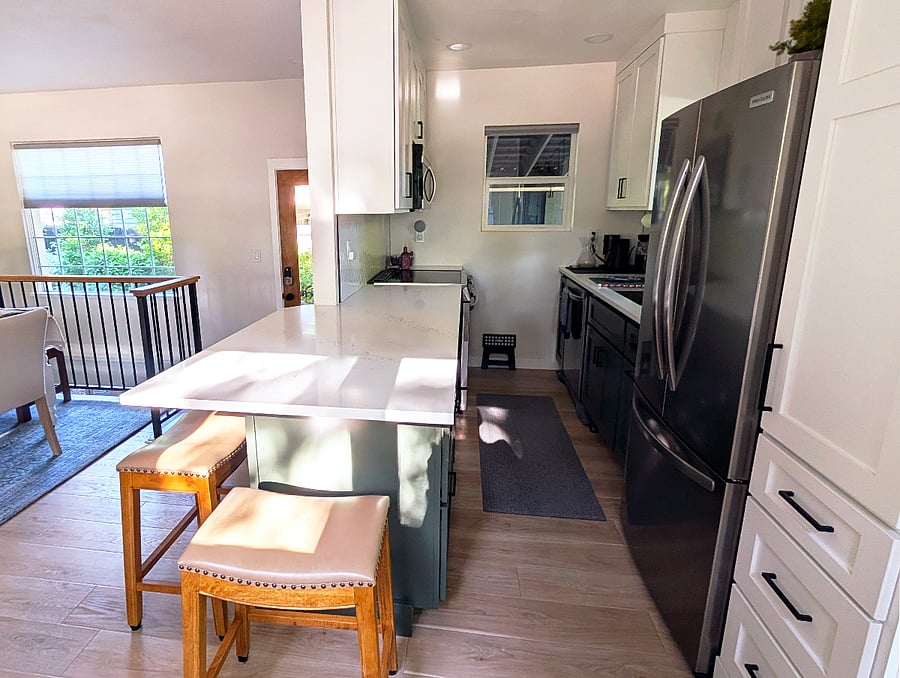 Kitchen with range/oven, microwave, dishwasher and full fridge