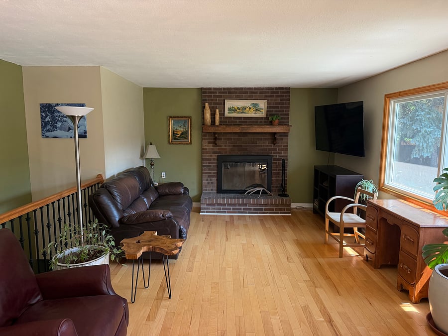 Living room: couch, recliner, desk, rocking chairs, Smart TV, open