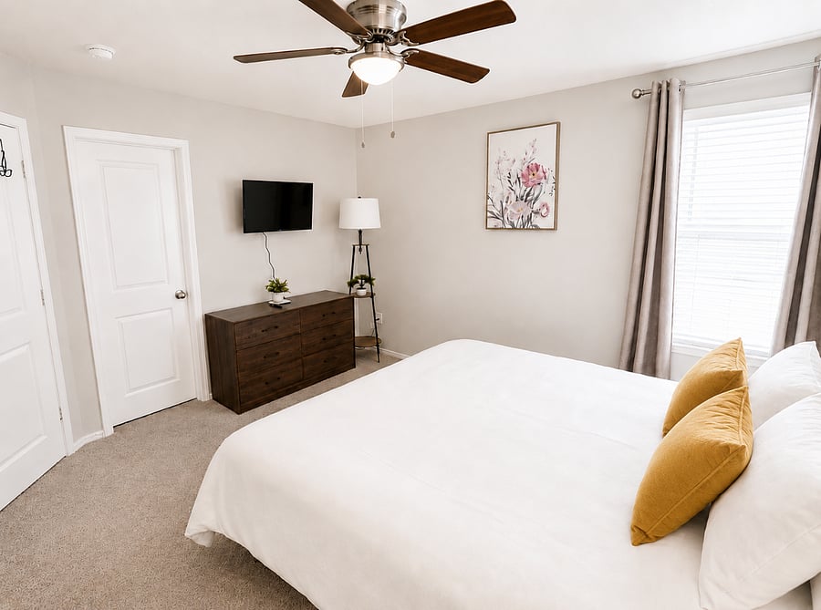Bedroom 1 - Spacious King bedroom with soft lighting, comfortable bedding, a smart TV and a walk-in closet