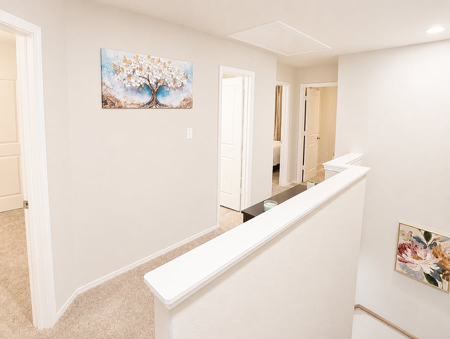 Upstairs hallway connecting bedrooms and bathrooms