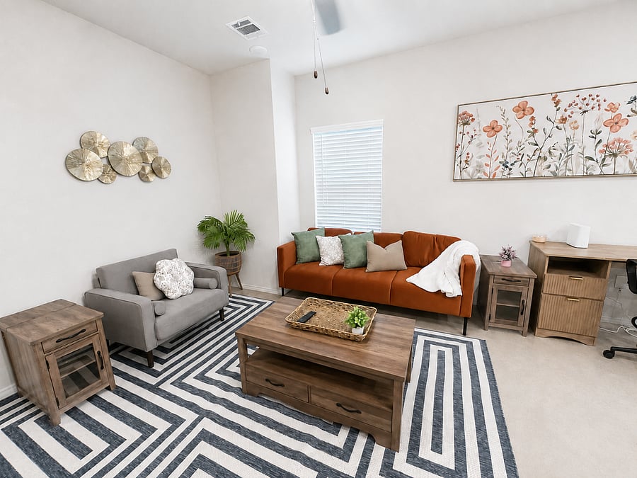 Cozy living space with plush seating, modern decor accents and a smart TV