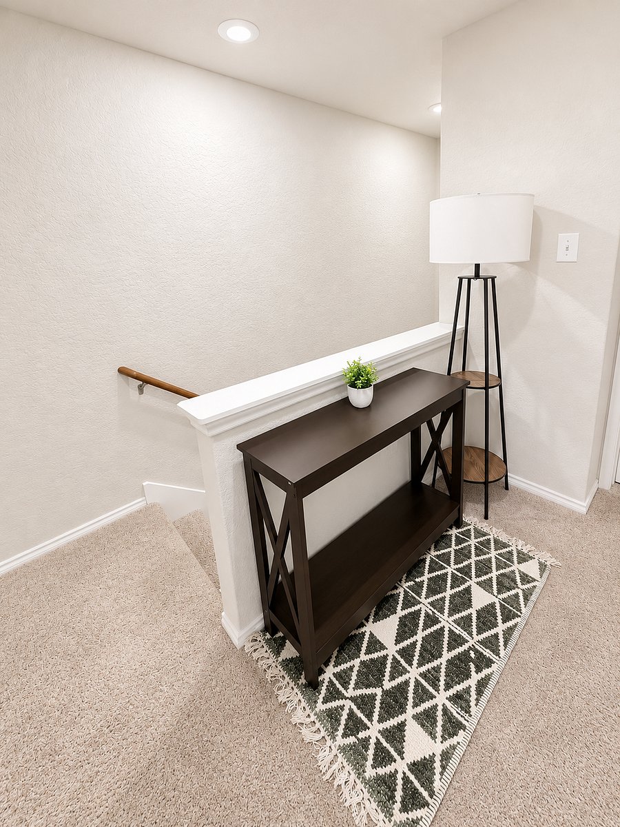 Upstairs hallway connecting all three bedrooms and two full bathrooms