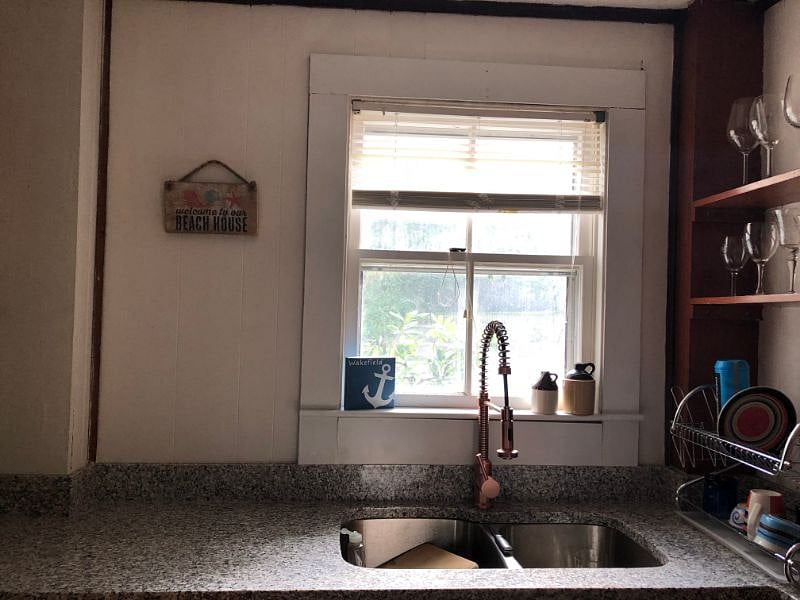 New copper faucet and granite counters in kitchen