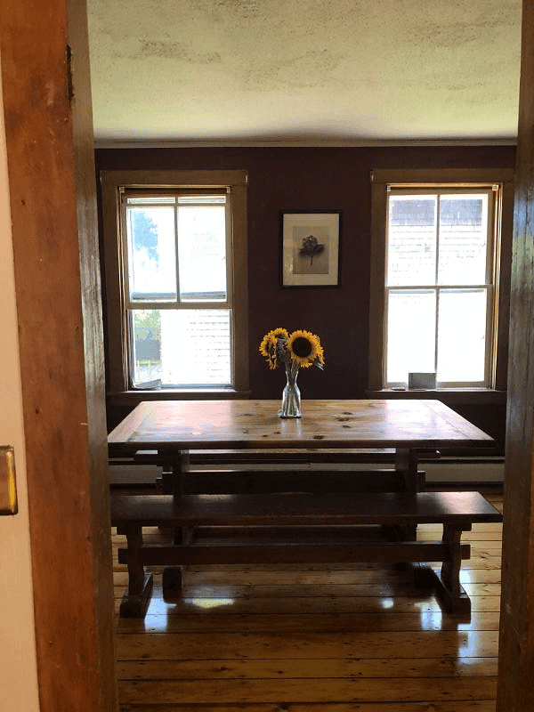 View from kitchen to dining room with original pine floors