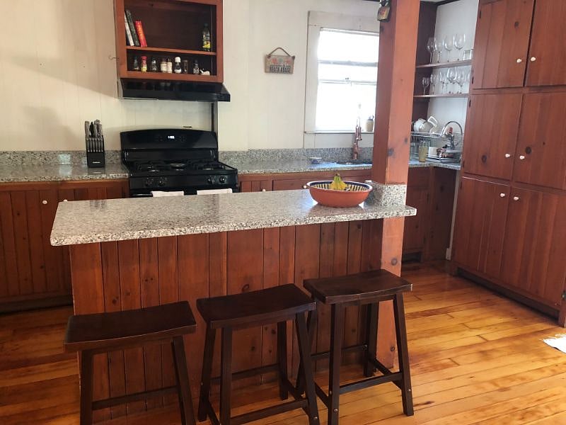 Breakfast bar and stools in kitchen, new granite counters throughout