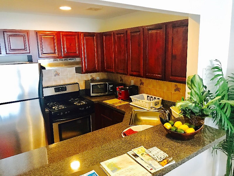 Kitchen with new stainless steel appliances. Coffee maker, kettle, toaster, plates, glasses.