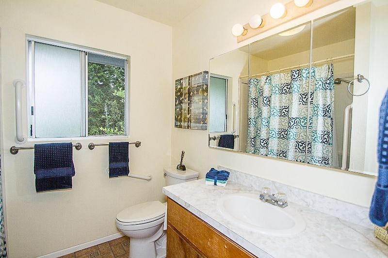 Main bathroom with tub/shower, large 3-door mirrored medicine cabinet, and large storage closet.