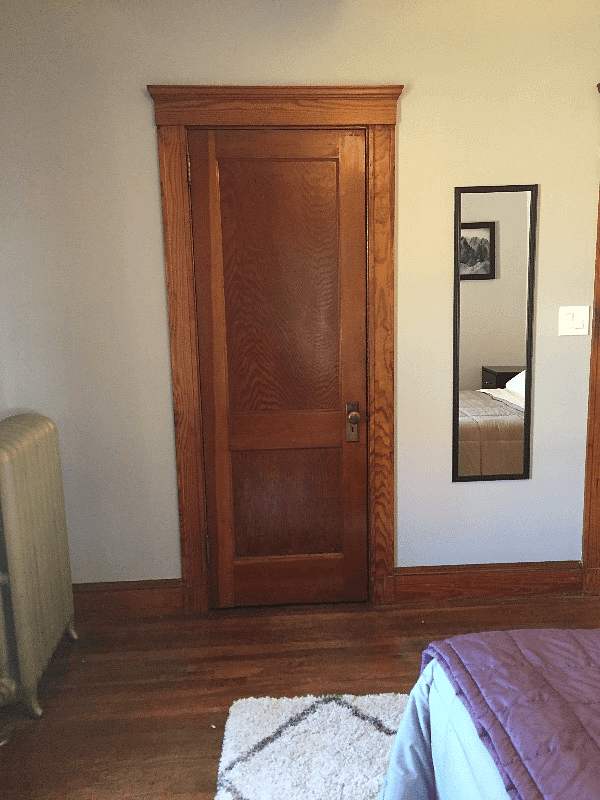 closet space runs length of this wall in back bedroom